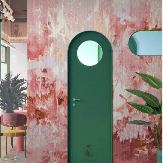 Green door with circular window on a textured pink wall