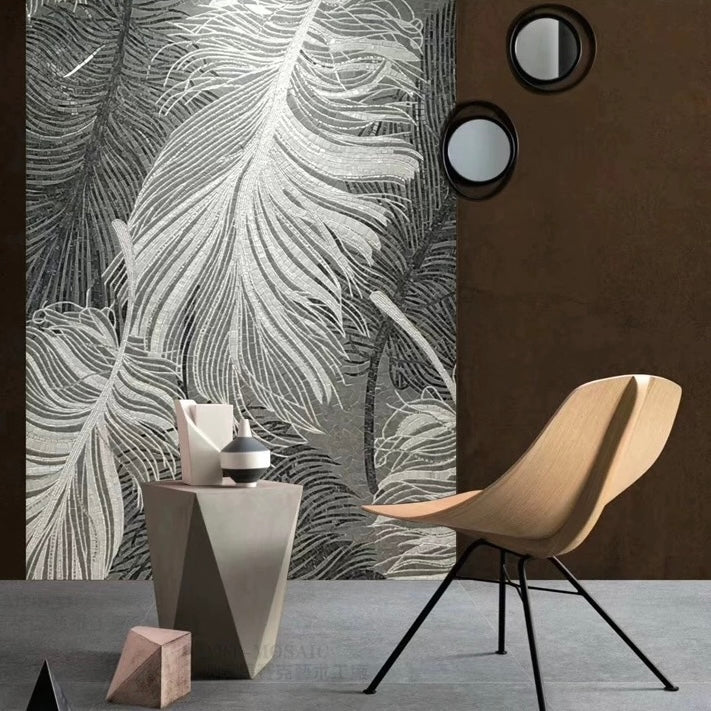 Modern interior with a wooden chair, geometric table, and feather-patterned mosaic wall mural.