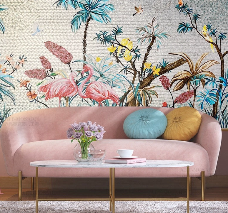 Pink sofa with colorful cushions against a wall with flamingo and floral mural.