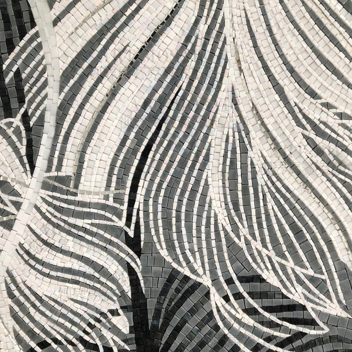 Mosaic pattern with black and white tiles forming feather-like shapes.