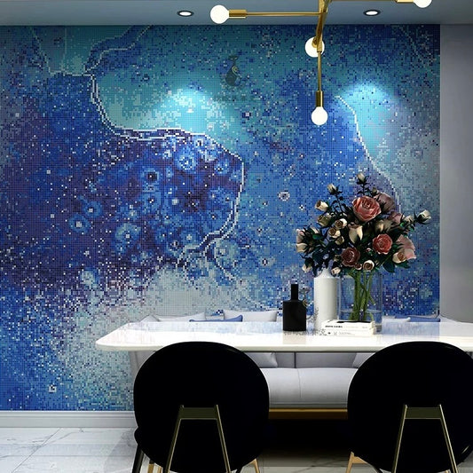 Dining area with a blue mosaic wall featuring a fish, black chairs, and a white table.
