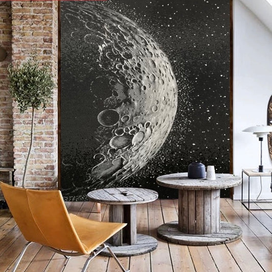Room interior with a large moon mosaic wall art piece, wooden furniture, and a plant.
