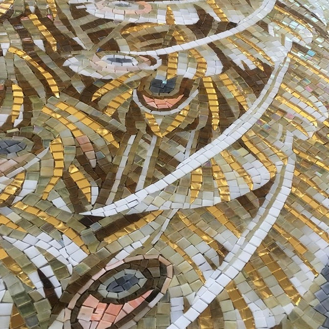 Mosaic artwork of a partial peacock with multicolored tiles.